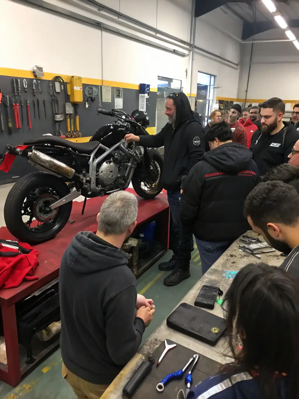 A photograph capturing a group of FMF 22 members conducting a roadside assistance training session for fellow motorcyclists, demonstrating practical skills and solidarity.